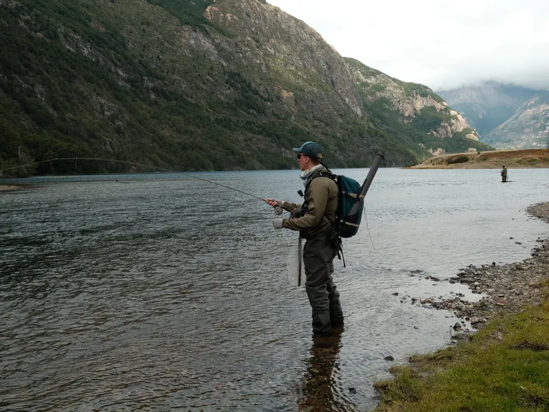 Fishing the lake, mountains rising behind