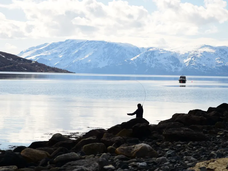 Casting from the rocks into the fjord