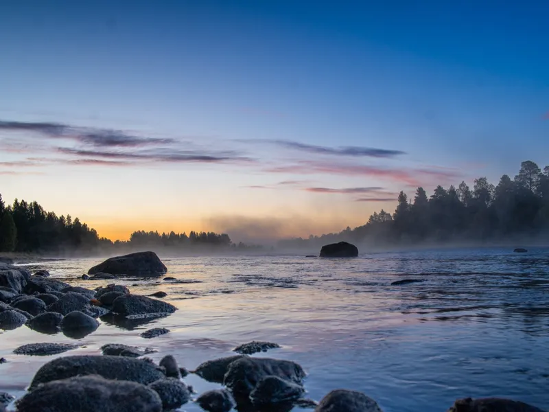 Dawn on the river, mist lifting off the water